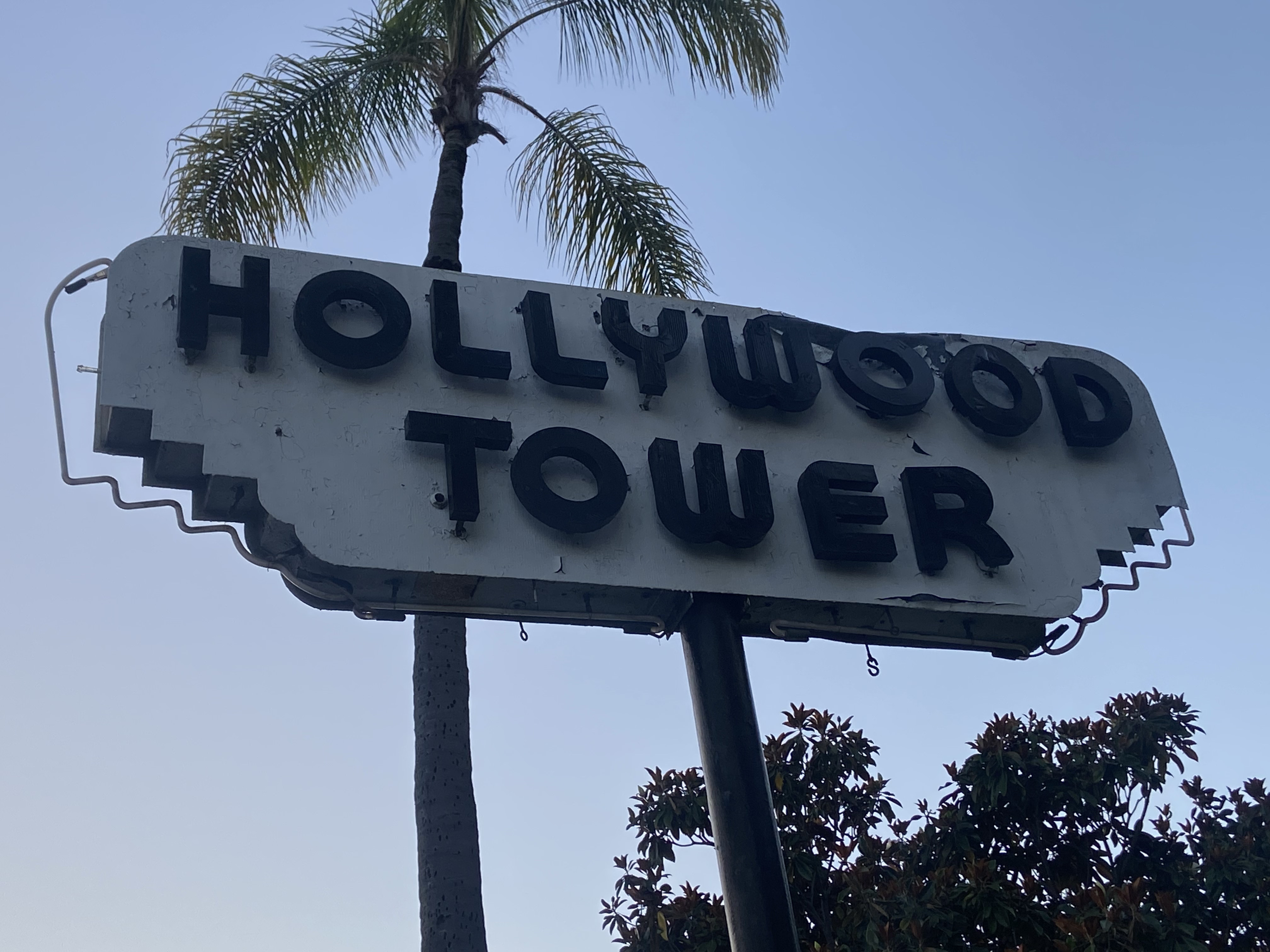 The Hollywood Tower neon sign today — unlit and weathered